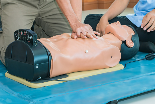 CPR aid dummy medical training with hand press Heart on doll emergency refresher training Concept closed-up.